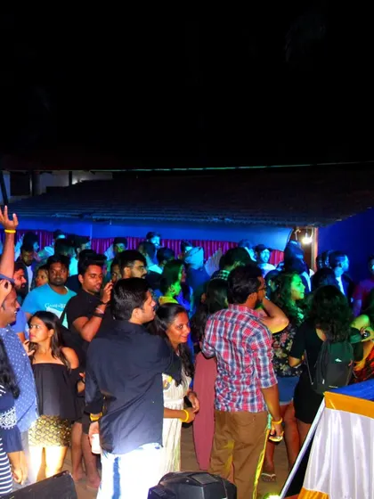 A candid shot of the crowd at an evening party, showing the lively and social environment I create.