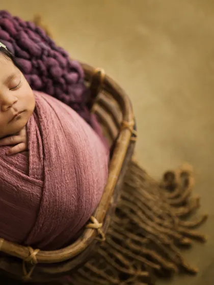 A creative angle of the baby in the basket, using negative space to create an artistic and modern feel.