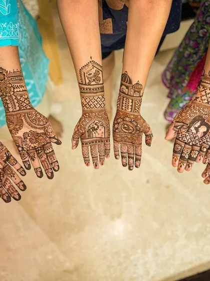 A group shot of mehendi for a wedding party, with each person having a unique yet complementary design.
