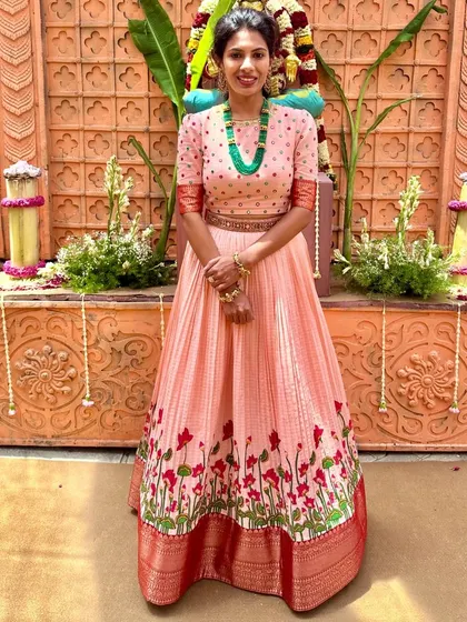 A full view of the peach anarkali, showcasing its beautiful flare and intricate border.