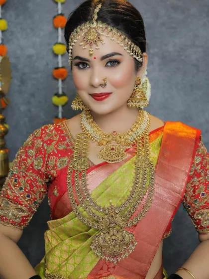 A beautiful portrait of a bride wearing a multi-layered temple jewellery set. The details on the choker and haram are simply breathtaking.