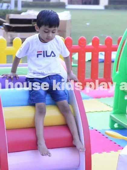 A child enjoying the rainbow roller slide, a fun and unique piece of our soft play equipment.