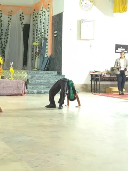 A wide shot of the backbend demonstration, showing the results of our comprehensive flexibility and mobility training program for kids.