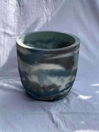 This large, 16-inch planter features a beautiful marbled pattern of blue, grey, and white. It’s a statement piece that can elevate any plant.