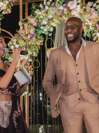 Sharing a laugh with a guest on stage during a wedding reception. Making personal connections and ensuring everyone feels comfortable is a key part of my hosting style.
