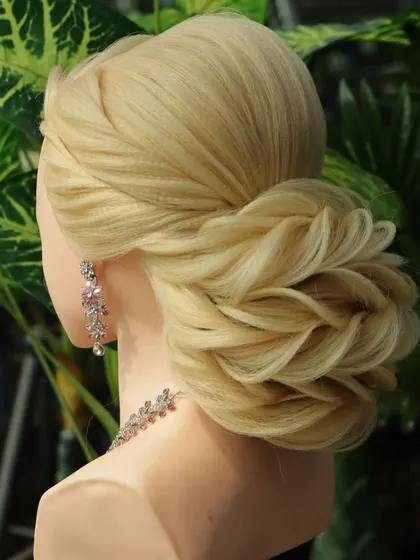 Another angle of the reception bun, showcasing its intricate side profile. I teach how to build these styles so they are beautiful and balanced from every view.