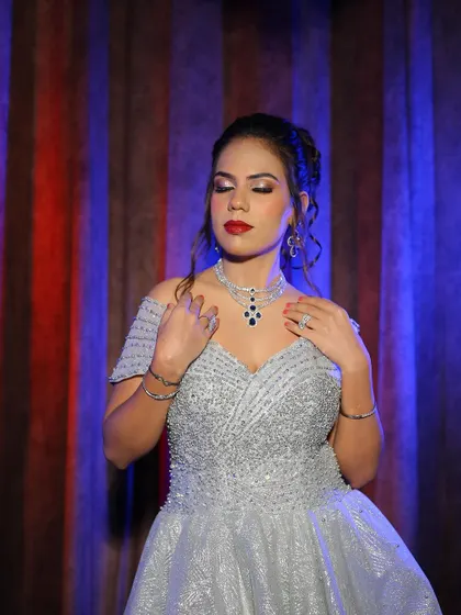 A front view of the silver-grey gown, highlighting the intricate beading on the bodice and the matching sapphire-style necklace.