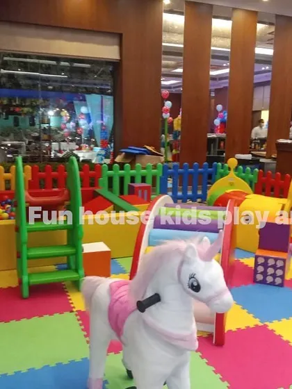 Our rainbow play area set up at The Palms in Gurgaon, featuring a rocking horse, slide, and ball pit.