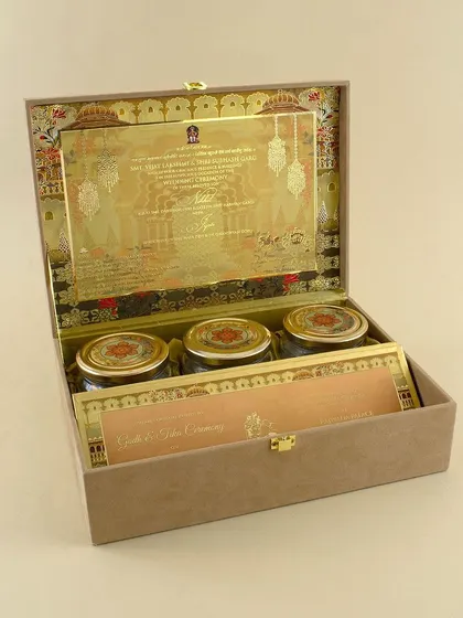 This sophisticated beige box features a gold-foiled palace design on the inner lid. It's designed to hold three gift jars and the main invitation, offering a complete and elegant package.