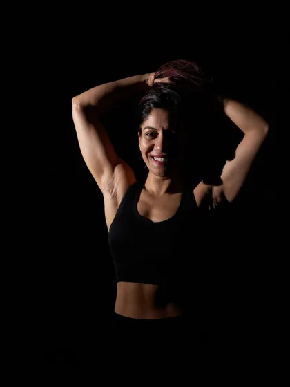 A dramatic, artistic shot that captures the strength and shadow of the fitness journey. It's not always bright and easy; it requires willpower and commitment, but the results are always worth it.