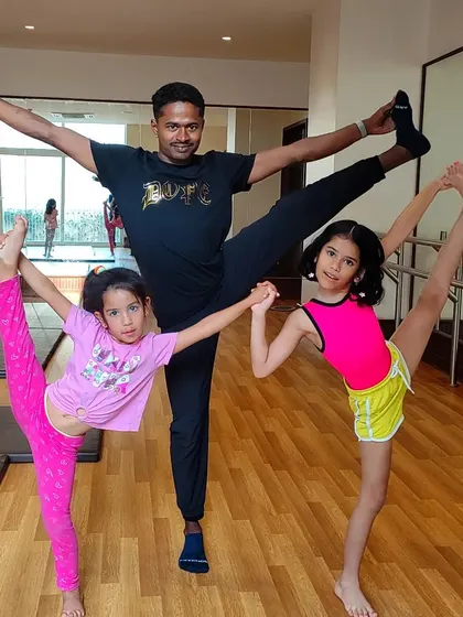 Coach Chandru celebrating Independence Day with two of his talented students, showcasing their amazing flexibility together.