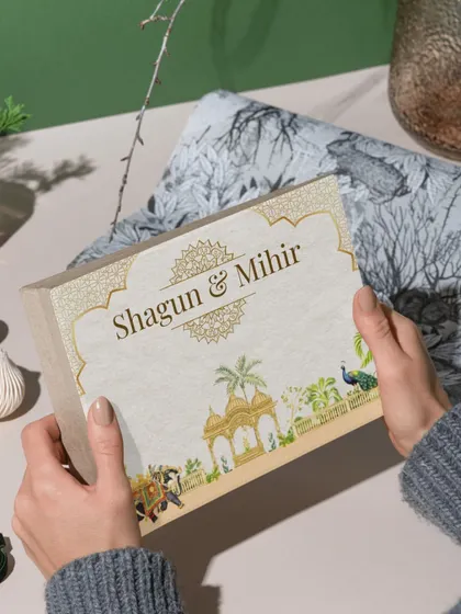 Here you can see the 'Shagun & Mihir' invitation box being held, giving a sense of its size and quality. A physical invitation is the first tangible piece of your wedding that guests receive, and I make sure it's absolutely perfect.