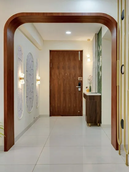 The full entryway composition, demonstrating how we balance different design elements like wood, metal, and light to create a harmonious entrance.