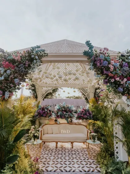 A beautiful gazebo seating area from the Bridgerton-themed event, adorned with pastel hydrangeas and surrounded by lush greenery. Perfect for a sophisticated garden party.