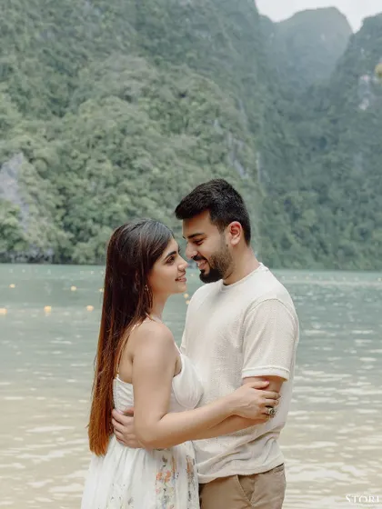 A romantic portrait of the couple against the stunning backdrop of Thailand's limestone karsts and clear waters.