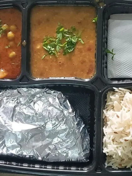A simple, everyday thali with aloo matar and dal. This is the core of my tiffin service, providing nutritious and tasty meals on a daily basis.