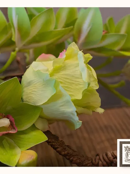 A close-up of a vibrant green and yellow artificial flower, showing the realistic texture and veining on the petals.