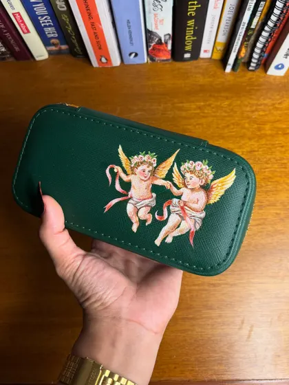 Another angle of the hand-painted jewelry case. The detail on the cherubs' wings and the flowing ribbons was painted with specialized, durable paints.