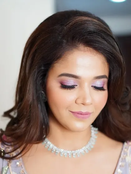 The focus here is on the dreamy, shimmering lilac eyeshadow. It's a perfect example of how a pop of color can elevate a look while still feeling elegant and sophisticated.