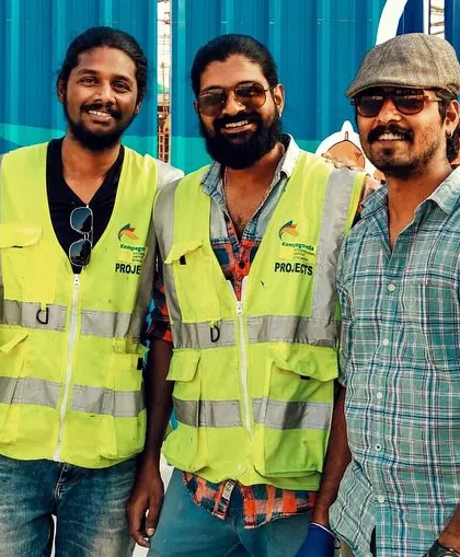 The Kalakarah team after wrapping up a large scale project. The safety vests and the finished art in the background capture the two sides of our work: professional execution and creative fulfillment.