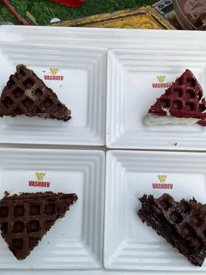 An assortment of our irresistible waffles, including classic, chocolate, and red velvet flavors. Our branded plates add a professional touch to the dessert experience.