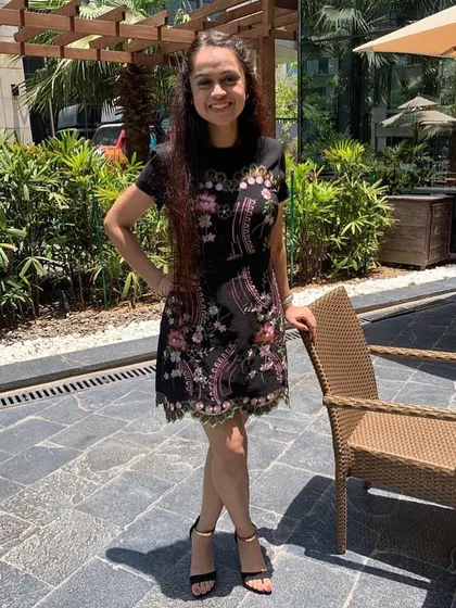 A close-up of the beautifully embroidered dress. The intricate floral pattern adds so much texture and visual interest, making it a standout piece for any daytime party or brunch.