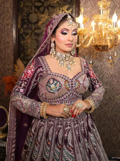 A portrait shot focusing on the intricate work of the blouse and the heavy bridal jewelry.