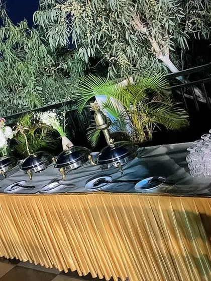 An outdoor buffet setup under the stars. We can cater in any location, bringing our full setup to create an unforgettable dining experience.