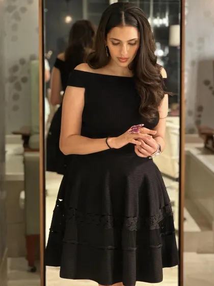 A different angle of the Alexander McQueen LBD, showing the intricate lace detail on the hem.