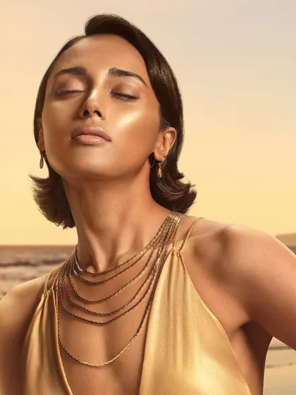 A serene and glowing beauty shot from the Chambor Geneva campaign. The model's highlighted skin and peaceful expression perfectly capture the essence of a radiant, sun-kissed makeup look.