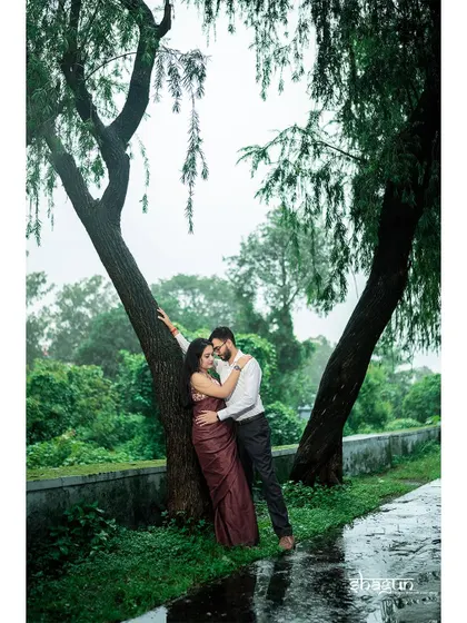 Finding shelter from the rain together under a tree. This intimate moment during a monsoon shoot is incredibly romantic and feels like a scene from a classic movie.