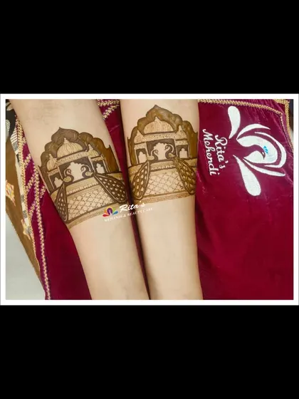 The startup bands on the arms, featuring traditional 'palki' or palanquin designs.