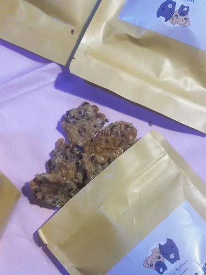 A close up of our Dehydrated Chicken & Flaxseed Cookies. Made with 100% minced chicken and roasted flax seeds, they are a crunchy, delicious, and nutritious snack.