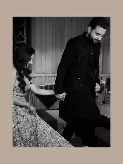 A black and white shot of the couple holding hands as they walk. This image focuses on their connection, creating a timeless and elegant pre-wedding portrait.
