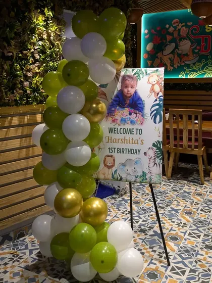 The personalized welcome easel for Harshita's party, matching the jungle theme and featuring a cute photo of the birthday girl.