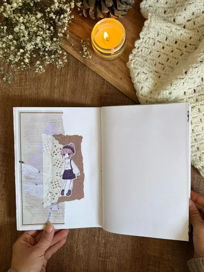 A collage page featuring a cute illustration and textured paper from the custom journals.
