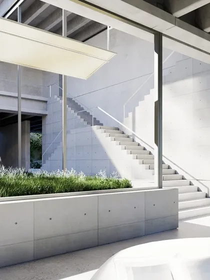 A view through the farmhouse's central courtyard, which contains planters and an open staircase. The design uses transparency and open circulation to connect different parts of the home.
