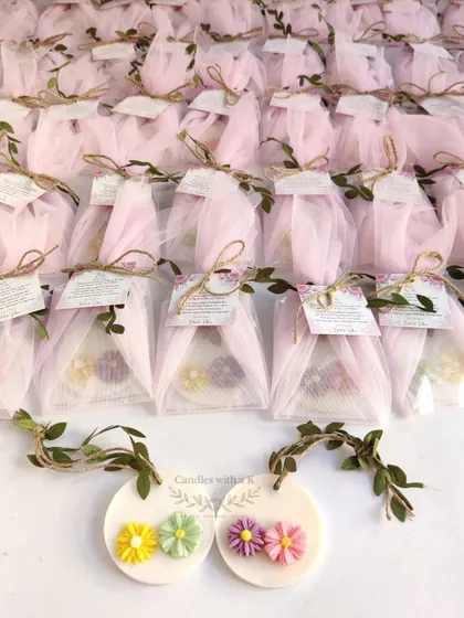 The wedding return gift sachets beautifully packaged in pink net with personalized thank you cards.