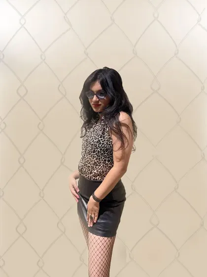 Some pre-show shenanigans, rocking a leopard print and leather skirt. This photo captures my rockstar aesthetic and the fun of getting ready for a gig.