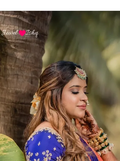 A serene portrait of the bride amidst nature. The soft lighting highlights her beautiful makeup and the intricate details of her temple jewellery.