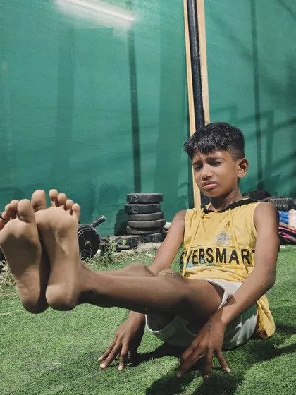 The face of pure effort. This young athlete is giving his all to perfect his L-sit form.