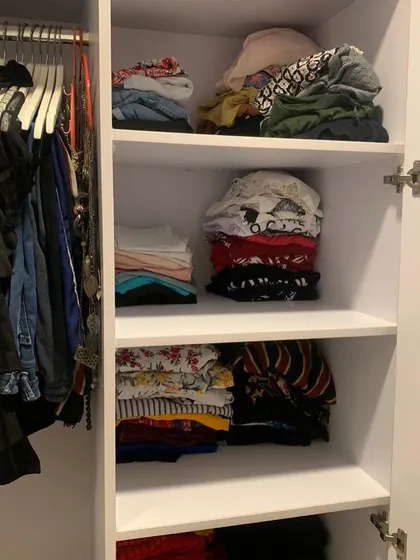 The "after" of a closet organization session. With everything neatly folded and hung, getting dressed in the morning becomes an enjoyable, stress-free experience.