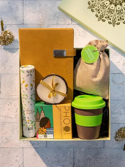 A closer look at our eco-friendly Diwali hamper. It features a stylish notebook, a reusable cup, a scented candle, and other thoughtfully sourced items, all presented in a beautiful mandala-print box.