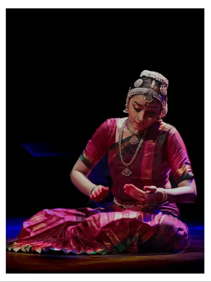 A seated abhinaya moment, where the Nayika is expressing her feelings through subtle gestures and facial expressions.