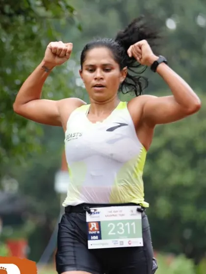 The finish line feeling. Arms up, celebrating a strong performance. This is the joy of achieving a goal you've worked tirelessly for. I help athletes experience this feeling of accomplishment.