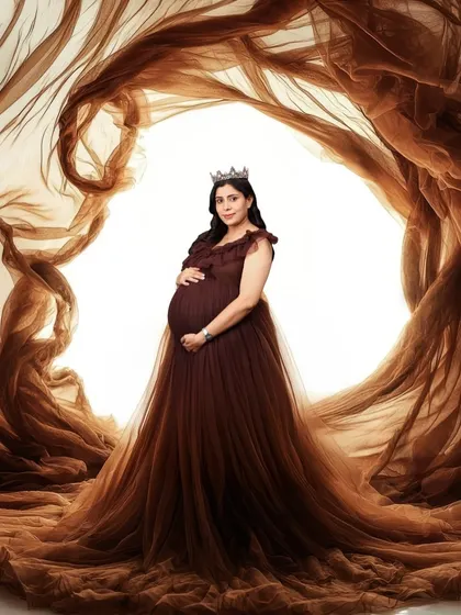 A dramatic and artistic portrait of a woman in a brown gown, enveloped in swirling brown fabric. The effect is powerful and elemental, like being at the heart of a beautiful storm.