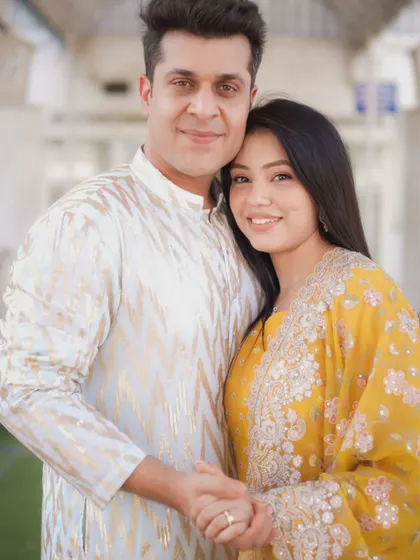 A sweet and simple pre-wedding portrait. The couple's coordinated yellow and white outfits and their comfortable embrace make for a lovely, natural shot.