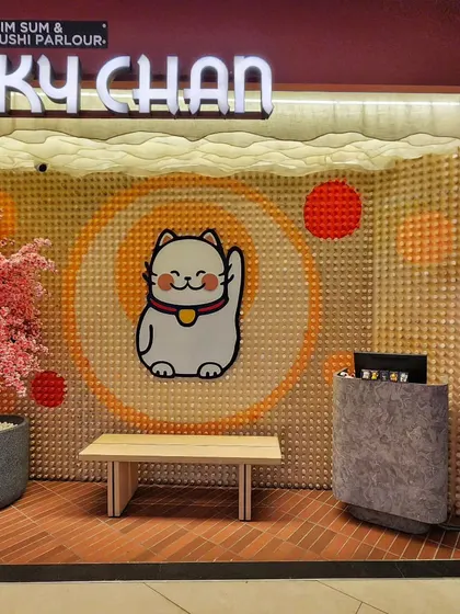 The full entrance view of our installation at Lucky Chan. The wooden peg wall creates a warm and inviting texture, making the brand's logo and character pop.