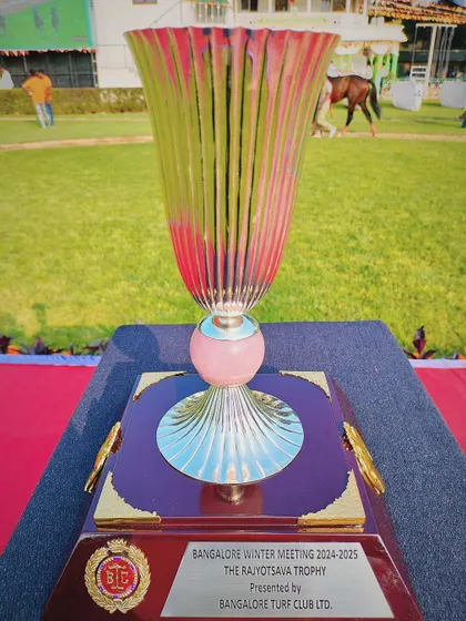 The Rajyotsava Trophy, a stunning fluted glass trophy with a pink hue.