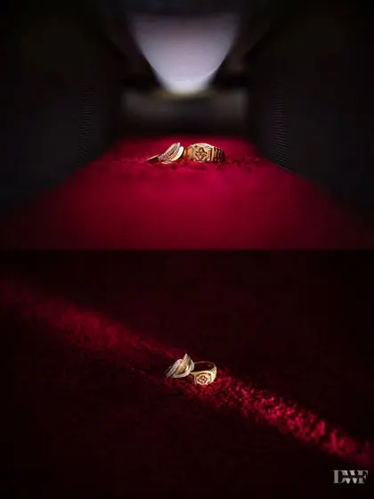 A creative and dramatic shot of the engagement rings, highlighted by a single beam of light. This photo turns a detail into a cinematic moment.